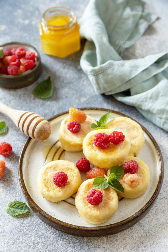 Homemade cottage cheese pancakes gluten free (syrniki, curd fritters) with berries.  - Stock Photo - Images