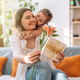 Daughter hugged her mother and gave a gift and flowers, mother&#39;s day - PhotoDune Item for Sale