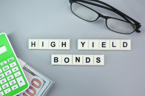 calculator, glasses and paper money with the alphabet word High-Yield Bonds