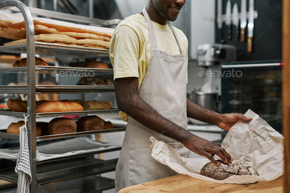 Bakery Worker Wrapping Bread - Stock Photo - Images