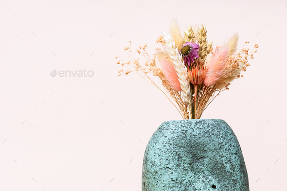 bouquet of dried plants in ceramic vase on pink - Stock Photo - Images