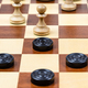 pawn and checkers piece in center of board closeup - PhotoDune Item for Sale