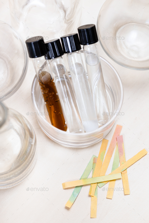 test tubes with liquids and used litmus papers - Stock Photo - Images