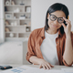 Smiling female accountant freelancer in glasses working looking at camera sitting at desk at home - PhotoDune Item for Sale