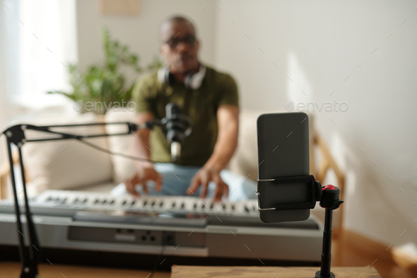 Artist Filming Himself Playing Synthesizer - Stock Photo - Images