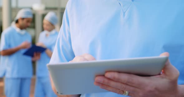Portrait of a Caucasian male surgeon working in a hospital, wearing face mask for hygiene against co alt