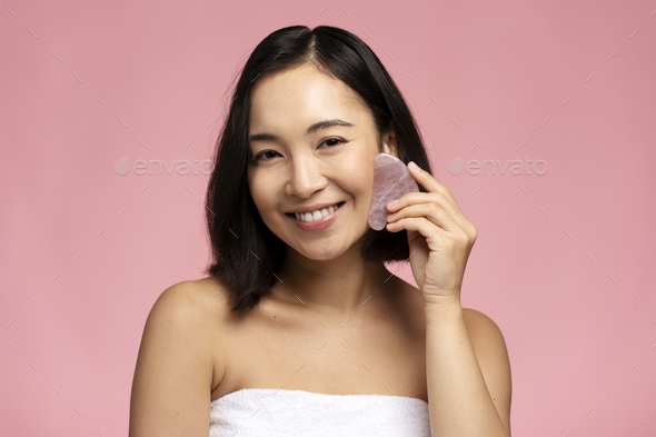 Portrait Of Smiling Beautiful Naked Asian Woman Using Facial Gua Sha Jade Board Stock Photo By