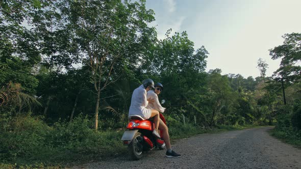 Love Couple on Red Motorbike in White Clothes to Go on Forest Road Trail Trip alt