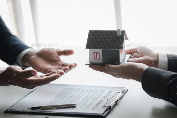 Real estate agents are holding a housing model of the project.