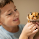 Boy holds funny hamster in his hands. Home pets. - PhotoDune Item for Sale