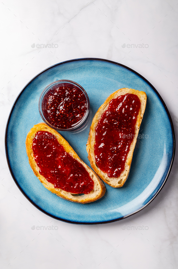 Raspberry jam on toast - Stock Photo - Images