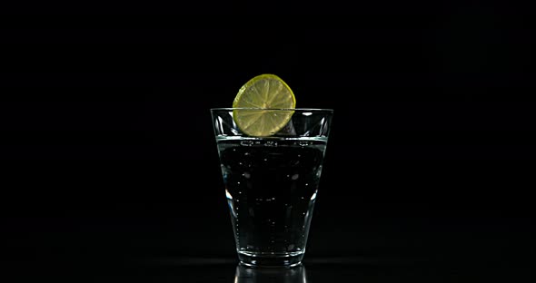 Slice of Green Citrus, citrus aurantifolia, in a Glass, Slow Motion 4K alt