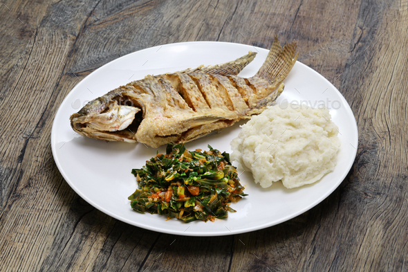 fried fish(Tilapia), ugali(white maize flour mash) and Sukuma Wiki(kale stew), Kenyan food - Stock Photo - Images
