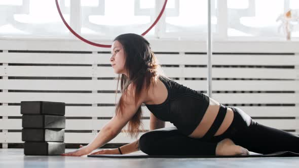 Fitness  a Young Woman Gymnast Doing Yoga on the Floor alt