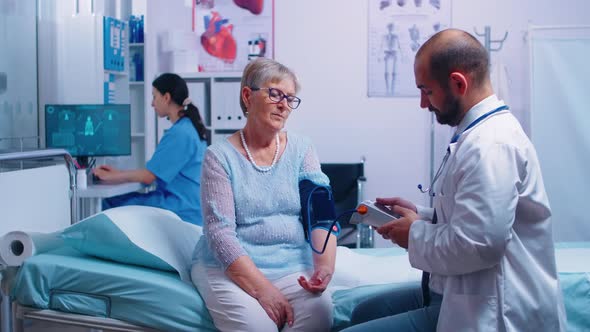 Nurse Writes Blood Pressure Levels alt
