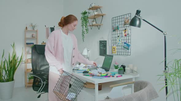 Female Designer Preparing Workspace for Doing Job alt