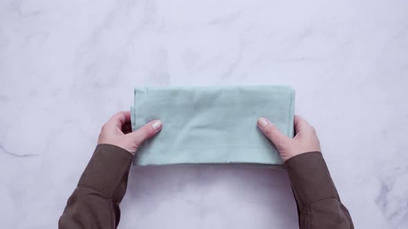 Stack of new linen dinner napkin on the kitchen counter. alt