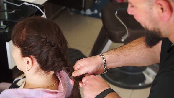 Master Man Makes Pigtails on Head of Young Girl