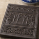Chinese tea brick from the Hubei Province close up in front of a tea pot - PhotoDune Item for Sale