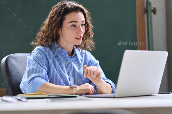Young woman, female teacher teaching online remote class working in office.