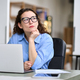 Thoughtful serious professional woman using laptop, looking away thinking. - PhotoDune Item for Sale