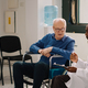 General practitioner doing consultation with old person in wheelchair - PhotoDune Item for Sale