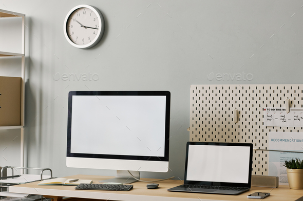Minimal office workplace setup with two screen mockups on desk