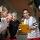 Female sport coach with clipboard discussing tactics with young and old women team training for - PhotoDune Item for Sale