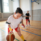 Multigenerational women playing basketball match in gym. - PhotoDune Item for Sale