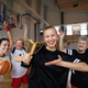 Group of young and old women, basketball team players, in gym with trophy celebrating victory. - PhotoDune Item for Sale
