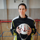 Close-up of woman floorball goalkeeper in helmet concetrating on game in gym. - PhotoDune Item for Sale