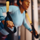 Close up of black athletic woman working out with suspension straps in gym. - PhotoDune Item for Sale