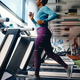 African American athlete jogging on treadmill during her sports training in gym. - PhotoDune Item for Sale