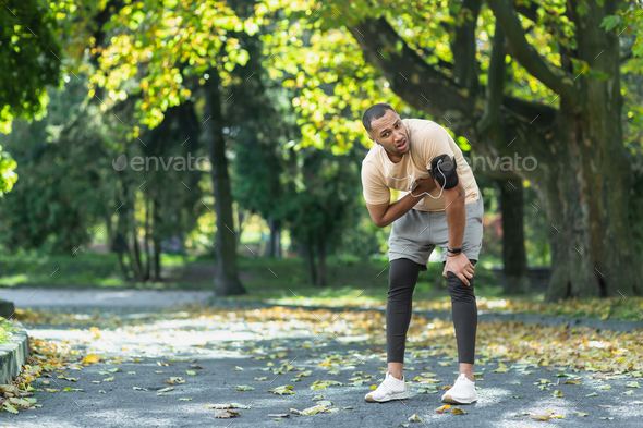 Sick man has severe heart pain after jogging, african american man holding hand to chest fast heart
