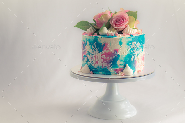 teal pink toned frosted cake with real roses topping for happy birth day party