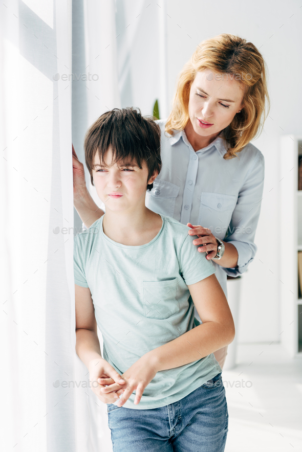 child psychologist hugging and talking to kid with dyslexia Stock Photo