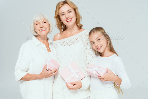 Grandmother And Granddaughter Wrapped In Towels Smile As They