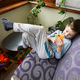 Boy plays phone on the sofa at balcony. - PhotoDune Item for Sale