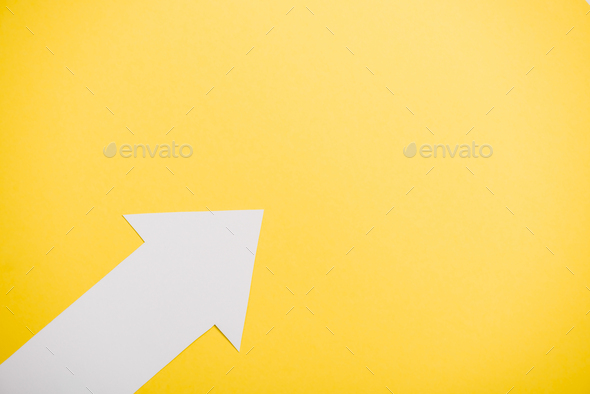 top view of directional arrow isolated on yellow with copy space - Stock Photo - Images