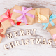 Gifts with colorful ribbons and inscription Merry Christmas, festive time concept - PhotoDune Item for Sale