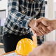 Architect and engineer construction workers shaking hands while working for teamwork and - PhotoDune Item for Sale