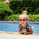 Happy little caucasian toddler girl with sunglasses smiling joyfully and enjoying summer vacations - PhotoDune Item for Sale