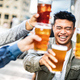 Group of happy multicultural young people drinking and toasting beer together - PhotoDune Item for Sale