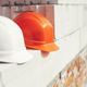 Hard hats on autoclaved aerated concrete blocks at construction site - PhotoDune Item for Sale