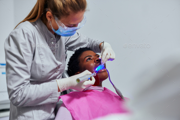 Dentist working teeth whitening dental medical process