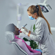 Female Dentist examining her patient in dental clinic - PhotoDune Item for Sale