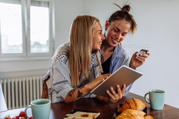 Young cheerful couple shopping online at home.