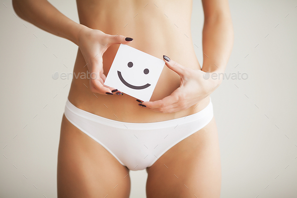 Female With Beautiful Fit Slim Body In White Panties Holding White Card  With Happy Smiley Face Stock Photo by maksymiv