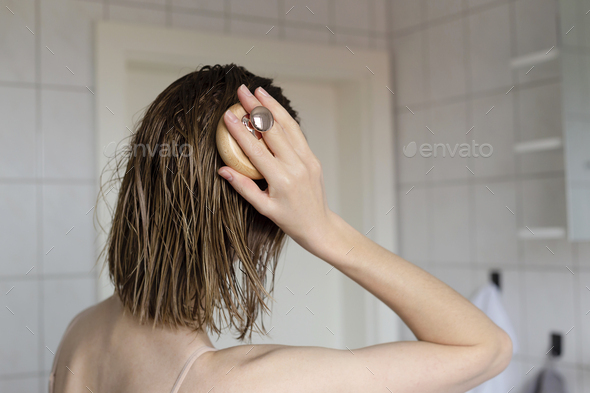 Woman makes a head self massage for hair growth. Stock Photo by svitlini