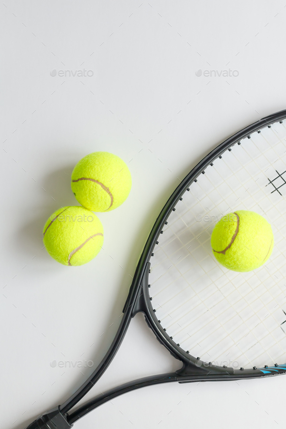 Big tennis sports equipment, racket and balls, layout on a white